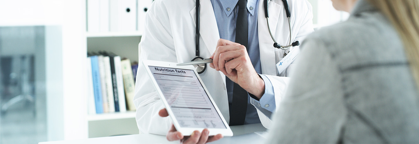 Image of a doctor showing nutritional facts on an iPad to a patient